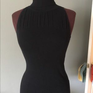 Dressy black sleeveless t-neck sweater top.